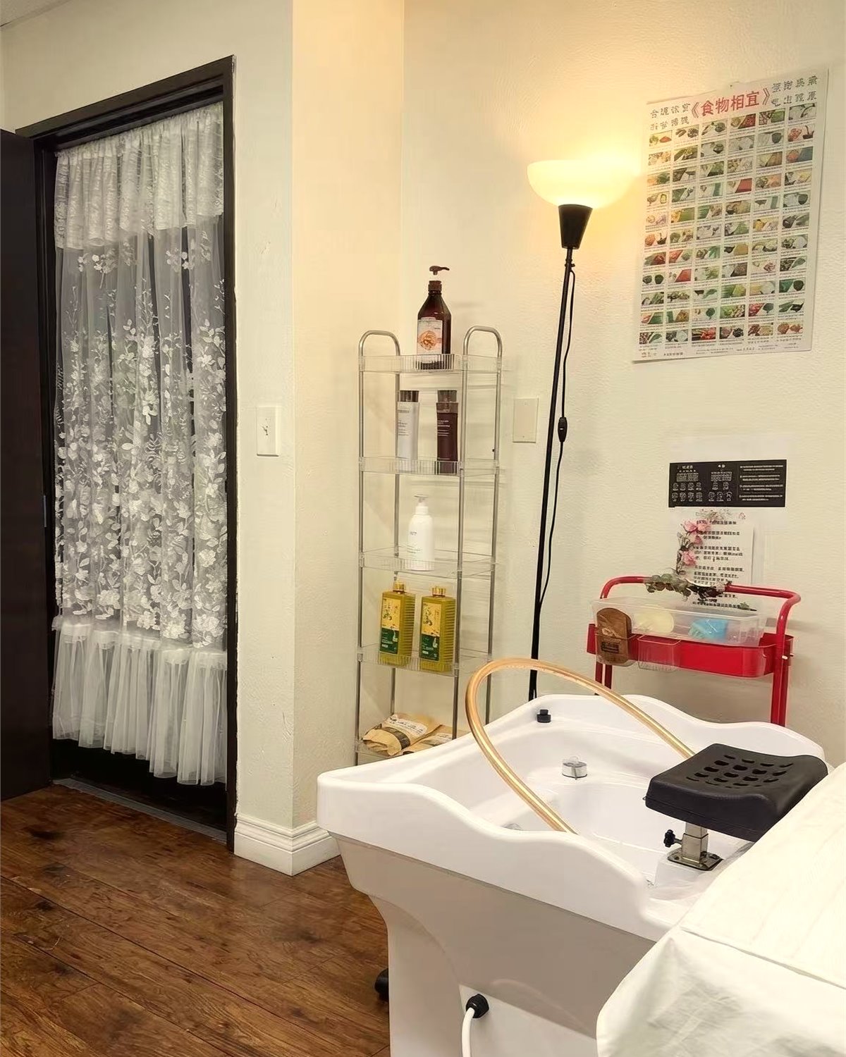Treatment suite with warm light, wood flooring, and a prepared spa station